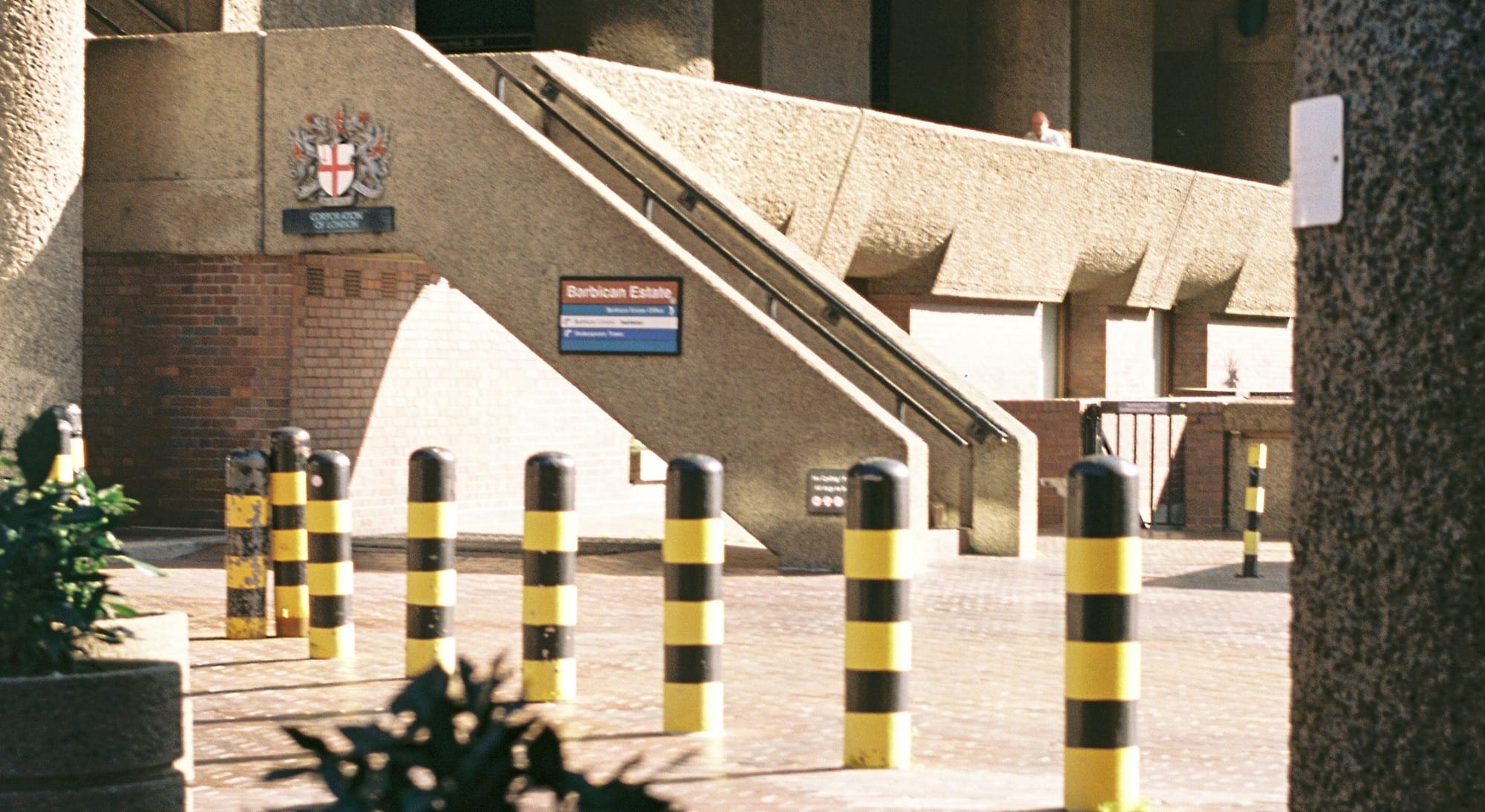 a building with a bunch of yellow and black striped bollards